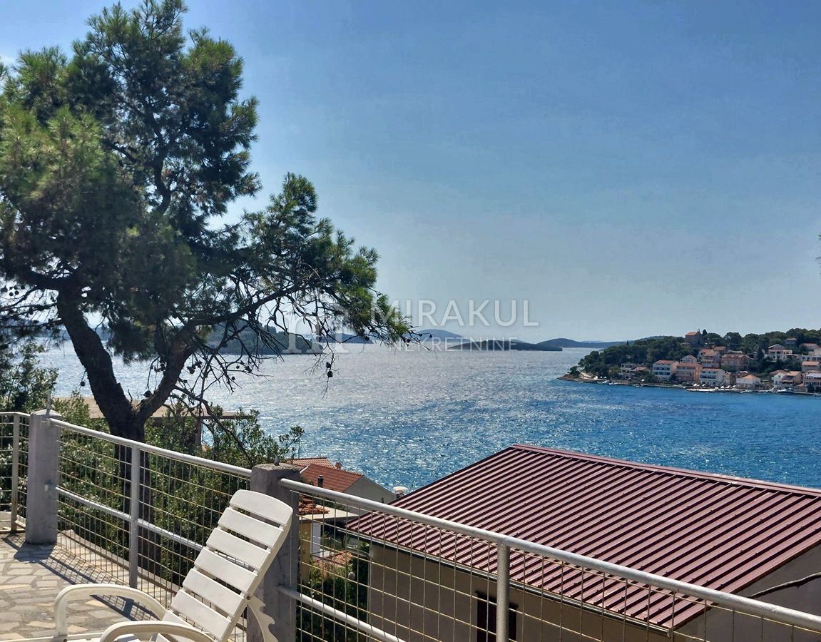 Real estate Tisno, House with a large garden and a beautiful view of the sea near the center